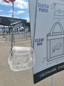 Photograph is of a clear acrylic purse that has "Bills Mafia" engraved inside of a buffalo. Setting for photoshoot is Highmark Stadium, home of the Buffalo Bills.