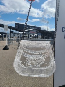 Photograph is of a clear acrylic purse that has "Bills Mafia" engraved inside of a buffalo. Setting for photoshoot is Highmark Stadium, home of the Buffalo Bills.