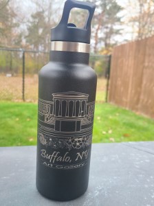 Photograph of engraved tumbler outside. Tumbler is engraved with a scene of the (original) Art Gallery in Buffalo, NY.