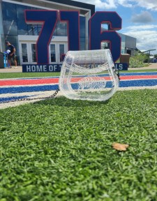 Photograph is of a clear acrylic purse that has "Bills Mafia" engraved inside of a buffalo. Setting for photoshoot is Highmark Stadium, home of the Buffalo Bills.