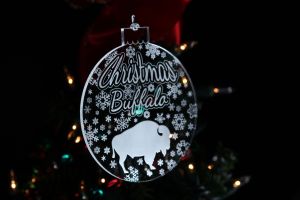 Christmas In Buffalo - 1/8" Clear Acrylic Ornament with beautiful snowflakes, and a buffalo.