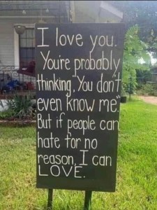 Sign in yard reading, "I love you. You're probably thinking, 'You don't even know me." But if people can hate for no reason, I can LOVE."