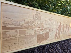 Custom wooden sign showcasing intricate laser-engraved scene of Canalside in Buffalo, New York. Each sign is custom framed in polished wood, reflecting the craftsmanship and artistry behind their creation.