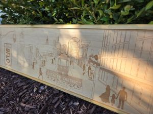 Custom wooden sign showcasing an intricate laser-engraved scene of Buffalo, New York's Theatre District. Each sign is custom framed in polished wood, reflecting the craftsmanship and artistry behind their creation.