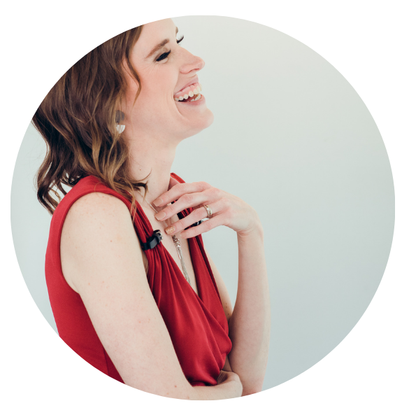 Photograph of owner - side profile, woman laughing with hand on chest.