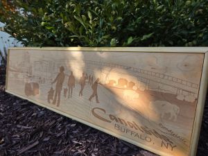 Custom wooden sign showcasing intricate laser-engraved scene of Canalside in Buffalo, New York. Each sign is custom framed in polished wood, reflecting the craftsmanship and artistry behind their creation.