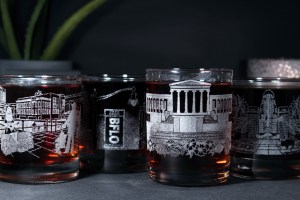 Picture City of Good Neighbors: The Collection featuring hand-drawn, custom engraved whiskey glasses.